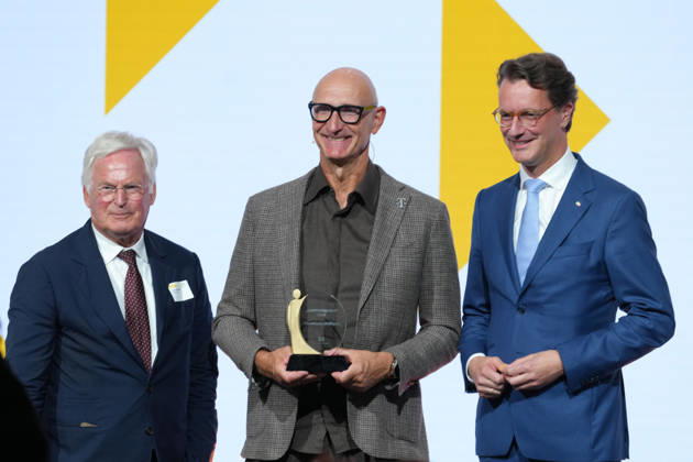 Brand Economy Day 2026: Franz Peter Falke on stage with Tim Hoettges, CEO of Telekom and winner of the Human Brand award, and Hendrik Wuest, Minister President of North Rhine-Westphalia, at Brand Economy Day 2026, Berlin, October 8, 2026, Berlin, Berlin, Germany