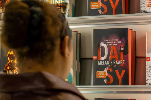 Frankfurt Book Fair 2026, August 10, 2026: A visitor looks at the books on display at a publisher’s booth at the Frankfurt Book Fair 2026. Books and visitors at the Fra