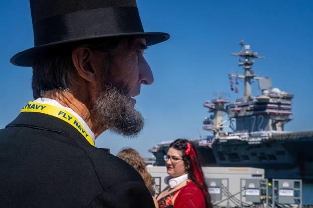 October 8, 2026, Coronado, California, United States: Robert Broski, a presenter who portrays Abraham Lincoln, watches the aircraft carrier USS Abraham Lincoln (CVN 72) during its homecoming at Naval Air Station North Island in Coronado, California, on October 8, 2026. Coronado United States - ZUMAg374 20261008_znp_g374_009 Copyright: xLoganxGrahamx