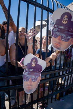 October 8, 2026, Coronado, California, United States: Family members and supporters wave and hold cardboard cutouts of a U.S. Navy sailor behind a fence as the aircraft carrier USS Abraham Lincoln (CVN 72) returns to Naval Air Station North Island in Coronado, California, on October 8, 2026, following a deployment. The cutouts depict a sailor wearing a Navy uniform and sunglasses. Coronado United States - ZUMAg374 20261008_znp_g374_012 Copyright: xLoganxGrahamx