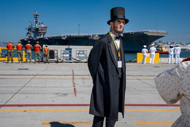 October 8, 2026, Coronado, California, United States: Robert Broski, an Abraham Lincoln presenter dressed in period attire, stands on the pier as the aircraft carrier USS Abraham Lincoln (CVN 72) returns to Naval Air Station North Island in Coronado, California, on October 8, 2026, following a deployment. Sailors and personnel gather along the waterfront as the carrier arrives. Coronado United States - ZUMAg374 20261008_znp_g374_020 Copyright: xLoganxGrahamx