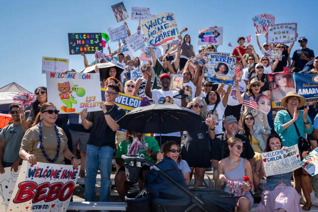 October 8, 2026, Coronado, California, United States: Family members and supporters cheer and hold handmade signs as the aircraft carrier USS Abraham Lincoln (CVN 72) returns to Naval Air Station North Island in Coronado, California, on October 8, 2026, following a deployment. The signs display personal messages welcoming sailors home, including Welcome Home Bebo and Welcome Home James. Coronado United States - ZUMAg374 20261008_znp_g374_021 Copyright: xLoganxGrahamx