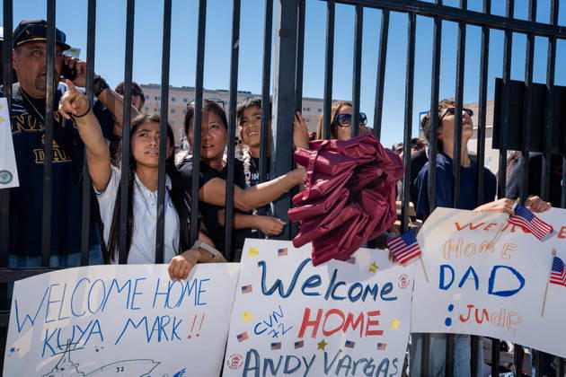 October 8, 2026, Coronado, California, United States: Family members and supporters hold handmade welcome-home signs and wave American flags as they await the return of the aircraft carrier USS Abraham Lincoln (CVN 72) at Naval Air Station North Island in Coronado, California, on October 8, 2026, following a deployment. Coronado United States - ZUMAg374 20261008_znp_g374_023 Copyright: xLoganxGrahamx