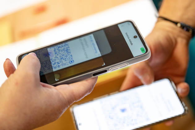 The two-day elections to municipal assemblies started in the Czech Republic together with the first round of the elections to one-third of the Senate, on October 9, 2026. On the photo a voter identifies himself at a polling station using the eDoklady app (digital ID copy) on his mobile phone before casting his vote in Hradec Kralove. (CTKxPhoto DavidxTanecek) CTKPhotoP2026100905645  CTKPhotoP2026100905645