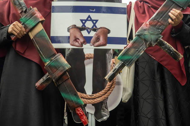 October 9, 2026, Kuala Lumpur, Malaysia: Protesters hold up mockup of depicting Israeli Prime Minister Netanyahu alongside mock cardboard weapons and placard during Global Day of Action: March for Palestine. Kuala Lumpur Malaysia - ZUMAr146 20261009_zap_r146_002 Copyright: xAsyrafxRasidx