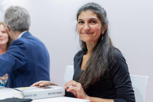 Frankfurt Book Fair 2026: Shida Bazyar, winner of the 2026 German Book Prize. In front of her is the award-winning book *Die Lücken*, Frankfurt am Main, Hesse, Germany, Exhibition Center