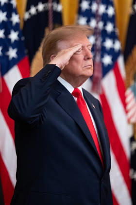 President Donald Trump salutes during the National Anthem during an event in the East Room of the White House in Washington, DC on Friday, Oct. 9, 2026. Trump is hosting a Columbus Day celebration. WASP20261009112 AaronxSchwartz