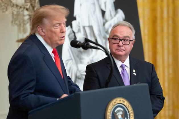 Brett Rugo, founder of Rugo Stone which constructed a helipad on the South Lawn, looks on as President Donald Trump speaks during an event in the East Room of the White House in Washington, DC on Friday, Oct. 9, 2026. Trump is hosting a Columbus Day celebration.  WASP20261009116 AaronxSchwartz