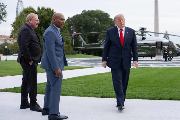 President Donald Trump walks with former professional boxer Mike Tyson and owner of the New York Yankees Randy Levine on the South Lawn of the White House before boarding Marine One in Washington, DC on Friday, Oct. 9, 2026. President Donald Trump is heading to Syracuse on Friday to boost Republican gubernatorial candidate Bruce Blakeman, who is trailing Governor Kathy Hochul in polls ahead of November s election. WASP20261009160 AaronxSchwartz