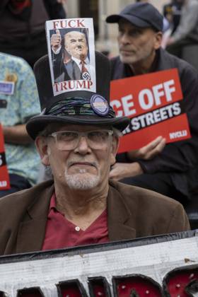 October 9, 2026, New York, New York, USA: A demonstrator wears a hat with an image of President Trump with a Hitler moustache that reads FUCK TRUMP at the Hands Off NYC coalition emergency protest outside Federal Plaza in Lower Manhattan demanding justice the day following ICE shooting a Bronx man while his 5 year child was in the car. New York USA - ZUMAr174 20261009_znp_r174_006 Copyright: xGinaxMxRandazzox
