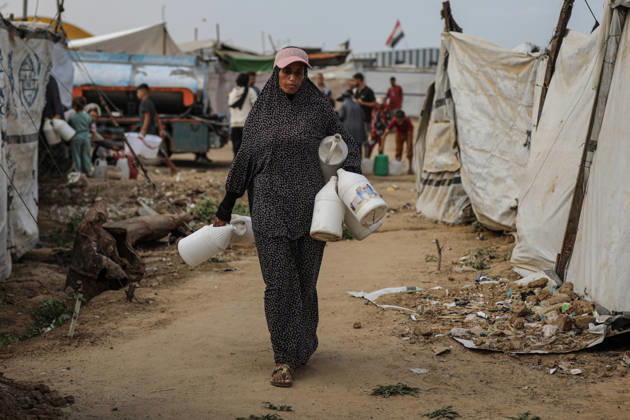 Palestinians still lack basic necessities amid Israel attacks DEIR AL BALAH, GAZA, PALESTINE - OCTOBER 10: Palestinians living in tents set up in the Bureij area carry water in containers to their makeshift shelters in Deir al Balah, Gaza, Palestine on October 10, 2026.The humanitarian crisis in the region continues to deepen, with thousands of displaced families struggling to survive without access to the most basic necessities. Adam Bilal Anadolu Deir al Balah Gaza. Editorial use only. Please get in touch for any other usage. Copyright: x2026xAnadoluxAdamxBilalx