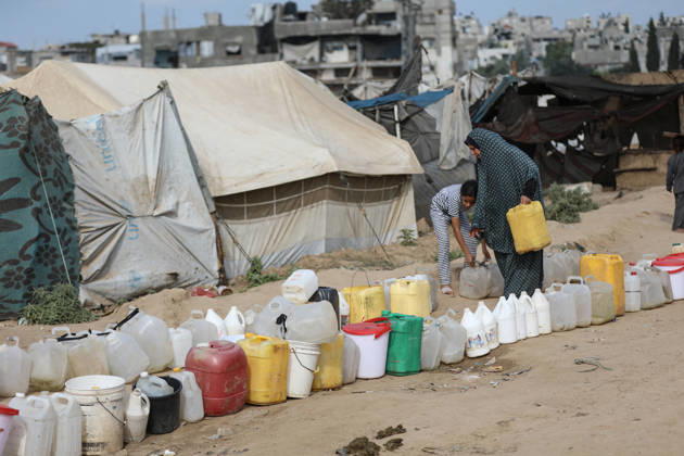 Palestinians still lack basic necessities amid Israel attacks DEIR AL BALAH, GAZA, PALESTINE - OCTOBER 10: Palestinians living in tents set up in the Bureij area carry water in containers to their makeshift shelters in Deir al Balah, Gaza, Palestine on October 10, 2026.The humanitarian crisis in the region continues to deepen, with thousands of displaced families struggling to survive without access to the most basic necessities. Adam Bilal Anadolu Deir al Balah Gaza. Editorial use only. Please get in touch for any other usage. Copyright: x2026xAnadoluxAdamxBilalx