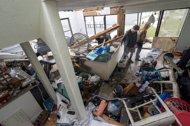 October 10, 2026, Pensacola Beach, Fl, USA: Laura and Alex Dean clean out their home that was severely damaged during Hurricane Isaias..Hurricane Isaias made landfall Friday, October 9 along the U.S. Gulf coast. Pensacola Beach USA - ZUMAs197 20261010_aaa_s197_037 Copyright: xJenxGolbeckx