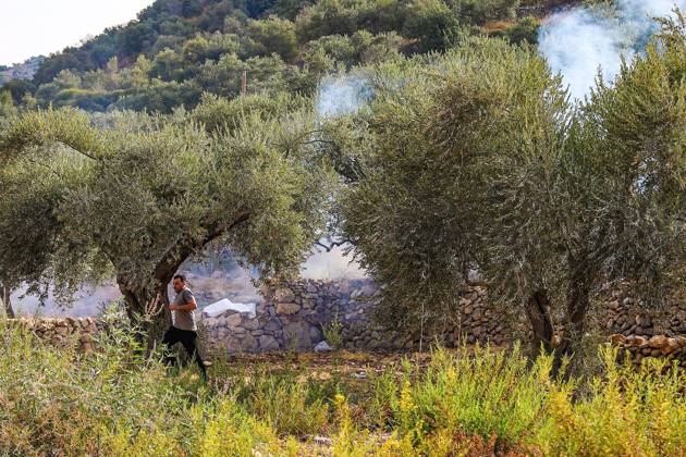 October 10, 2026, Ramallah: DEIR ABU MASHâ€⠢AL, PALESTINE †OCTOBER 10, 2026: Palestinian farmers came under attack by Israeli settlers and Israeli forces as they headed to harvest olives on their land in Deir Abu Mashâ€⠢al, northwest of Ramallah. The event marked the villageâ€⠢s first olive harvest gathering of the new season. The Palestine Red Crescent Society reported that its teams treated nine people injured during the incident. The injuries included one caused by live ammunition to the thigh, two caused by rubber-coated metal bullets, and six resulting from physical assault. One of those struck by a rubber-coated metal bullet was photojournalist Issam Al-Rimawi. The incident occurred during the annual olive harve - ZUMAq101 20261010_zna_q101_052 Copyright: xSalmanxMohsenxAlkhatibx