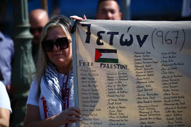 October 10, 2026, Athens, Attica, GREECE: A woman holds a banner bearing the names of Palestinians children killed in Gaza during a pro-Palestinian demonstration. Athens GREECE - ZUMAx103 20261010_zip_x103_002 Copyright: xHarrisxXanthopoulosx