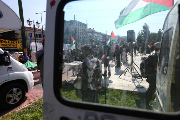 October 10, 2026, Athens, Attica, GREECE: A pro-Palestinian demonstration is seen through the window of a parked vehicle as protesters gather with Palestinian flags and banners. Athens GREECE  - ZUMAx103 20261010_zip_x103_004 Copyright: xHarrisxXanthopoulosx
