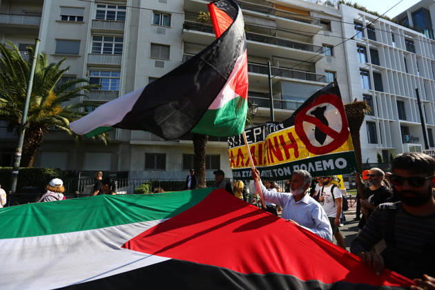 October 10, 2026, Athens, Attica, GREECE: Protesters carry a large Palestinian flag and an anti-war banner during a march in solidarity with Palestine. Athens GREECE - ZUMAx103 20261010_zip_x103_009 Copyright: xHarrisxXanthopoulosx