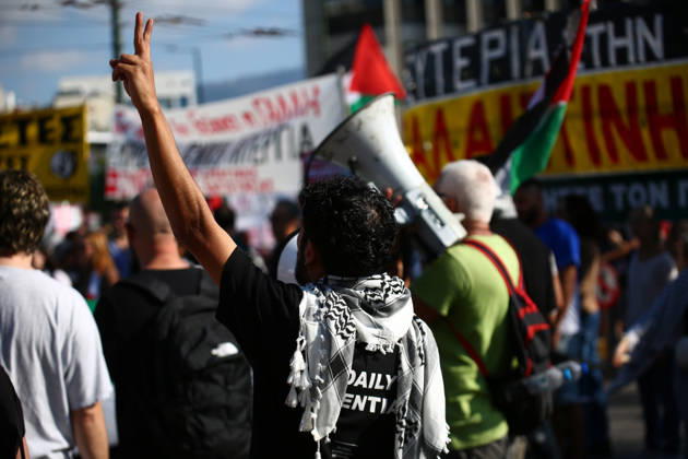 October 10, 2026, Athens, Attica, GREECE: A demonstrator wearing a Palestinian keffiyeh raises a victory sign during a pro-Palestinian protest. Athens GREECE  - ZUMAx103 20261010_zip_x103_028 Copyright: xHarrisxXanthopoulosx