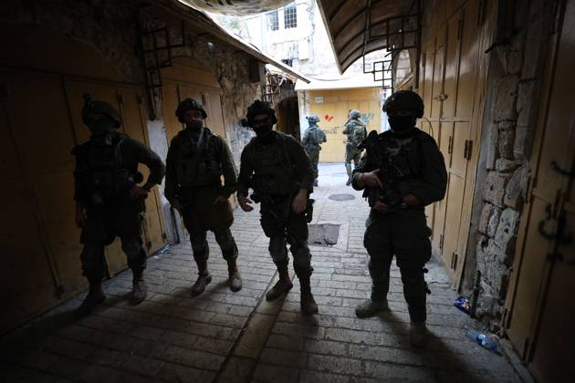 Israeli settlers enter Hebron Old City under military protection HEBRON, OCCUPIED WEST BANK, OCTOBER 10, 2026: Israeli settlers enter Hebron s Old City under the protection of Israeli forces during an organized visit to the area. Israeli soldiers deployed along streets and around the group as settlers moved through the Old City, where Israeli settlers and Palestinian residents live in close proximity amid longstanding tensions and movement restrictions. HEBRON Palestine, State of Copyright: x xMosabxshawerx xJNAxPressx