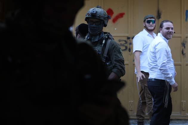 Israeli settlers enter Hebron Old City under military protection HEBRON, OCCUPIED WEST BANK, OCTOBER 10, 2026: Israeli settlers enter Hebron s Old City under the protection of Israeli forces during an organized visit to the area. Israeli soldiers deployed along streets and around the group as settlers moved through the Old City, where Israeli settlers and Palestinian residents live in close proximity amid longstanding tensions and movement restrictions. HEBRON Palestine, State of Copyright: x xMosabxshawerx xJNAxPressx