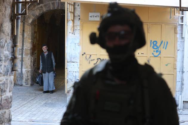 Israeli settlers enter Hebron Old City under military protection HEBRON, OCCUPIED WEST BANK, OCTOBER 10, 2026: Israeli settlers enter Hebron s Old City under the protection of Israeli forces during an organized visit to the area. Israeli soldiers deployed along streets and around the group as settlers moved through the Old City, where Israeli settlers and Palestinian residents live in close proximity amid longstanding tensions and movement restrictions. HEBRON Palestine, State of Copyright: x xMosabxshawerx xJNAxPressx