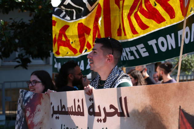 October 10, 2026, Athens, Attica, GREECE: A demonstrator wearing a Palestinian keffiyeh marches behind a banner calling for freedom for Palestine. Athens GREECE - ZUMAx103 20261010_zip_x103_015 Copyright: xHarrisxXanthopoulosx