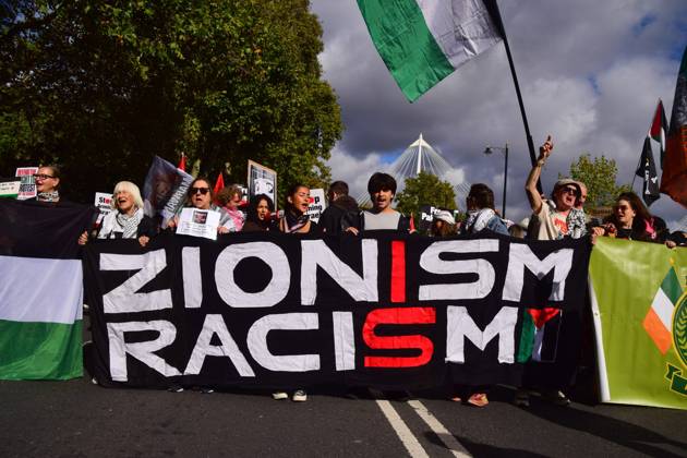 October 10, 2026, London, United Kingdom: Protesters hold a Zionism is racism banner during the National March for Palestine..Thousands of people marched in Central London marking three years of what the protest organisers call the genocide against the Palestinian people in Gaza London United Kingdom - ZUMAs197 20261010_aaa_s197_172 Copyright: xVukxValcicx