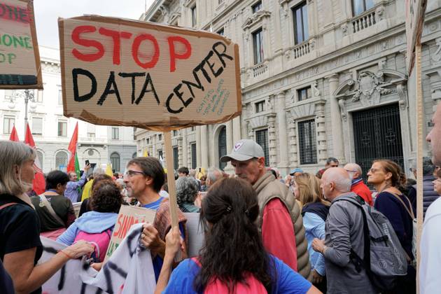 October 10, 2026, Milan, Italy: MILAN, ITALY †OCTOBER 10, 2026: Protesters gather for a sit-in in Piazza della Scala in central Milan to oppose the development of new data centers across Lombardy and Italy. The demonstration is organized by the Rete dei Comitati No Data Center (No Data Center Committee Network), which is calling for a moratorium on permits for new facilities. The group also urges public authorities to conduct thorough environmental, urban planning and regional assessments before approving projects. For approved facilities that have not yet begun operating, campaigners are calling for reviews to be reopened if potential microclimate effects and cumulative impacts with existing facilities were not adequately assessed. - ZUMAq101 20261010_zna_q101_176 Copyright: xCalogeroxRussox