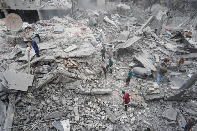 Israeli attack on Az-Zawayda area in Gaza DEIR AL-BALAH, GAZA, PALESTINE - OCTOBER 11: People search through the rubble of a building belonging to the Buheysi family following an Israeli airstrike in the town of Az-Zawayda, near Deir al-Balah in the central Gaza Strip, on October 11, 2026. Israeli forces carried out the strike despite the ceasefire, destroying the building and damaging surrounding structures. Adam Bilal Anadolu Deir Al-Balah Gaza. Editorial use only. Please get in touch for any other usage. Copyright: x2026xAnadoluxAdamxBilalx