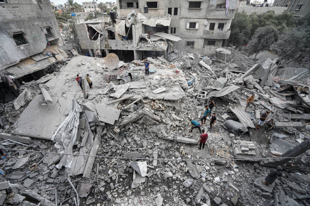 Israeli attack on Az-Zawayda area in Gaza DEIR AL-BALAH, GAZA, PALESTINE - OCTOBER 11: People search through the rubble of a building belonging to the Buheysi family following an Israeli airstrike in the town of Az-Zawayda, near Deir al-Balah in the central Gaza Strip, on October 11, 2026. Israeli forces carried out the strike despite the ceasefire, destroying the building and damaging surrounding structures. Adam Bilal Anadolu Deir Al-Balah Gaza. Editorial use only. Please get in touch for any other usage. Copyright: x2026xAnadoluxAdamxBilalx