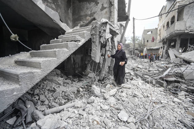 Israeli attack on Az-Zawayda area in Gaza DEIR AL-BALAH, GAZA, PALESTINE - OCTOBER 11: A woman stands amid the rubble near a damaged staircase following an Israeli airstrike targeting a building belonging to the Buheysi family in the town of Az-Zawayda, near Deir al-Balah in the central Gaza Strip, on October 11, 2026. Israeli forces carried out the strike despite the ceasefire, destroying the targeted building and damaging surrounding structures. Adam Bilal Anadolu Deir Al-Balah Gaza. Editorial use only. Please get in touch for any other usage. Copyright: x2026xAnadoluxAdamxBilalx