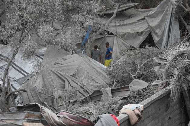 Israeli attack on Az-Zawayda area in Gaza DEIR AL-BALAH, GAZA, PALESTINE - OCTOBER 11: People stand near damaged tents and makeshift shelters following an Israeli airstrike targeting a building belonging to the Buheysi family in the town of Az-Zawayda, near Deir al-Balah in the central Gaza Strip, on October 11, 2026. Israeli forces carried out the strike despite the ceasefire, destroying the targeted building and damaging surrounding structures. Adam Bilal Anadolu Deir Al-Balah Gaza. Editorial use only. Please get in touch for any other usage. Copyright: x2026xAnadoluxAdamxBilalx