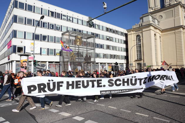 Protesters march with a banner reading Review today, Schütz tomorrow at the data center during a demonstration calling for the Federal Constitutional Court to review far-right parties, Potsdam, October 10, 2026. Review demonstration in Potsdam