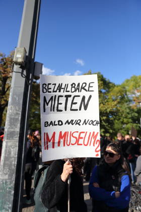 A protester stands with a sign reading Affordable Rent Soon Only in a Museum at Unity Square during a demonstration against the housing crisis and rising rents, Potsdam, October 10, 2026. Rent Protest in Potsdam