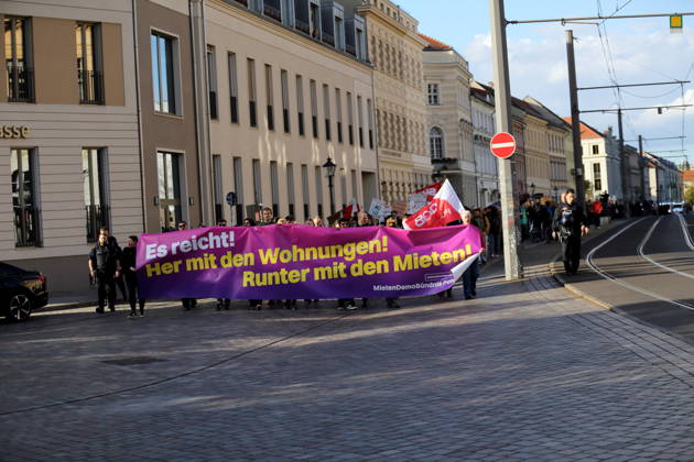 Protesters march down Friedrich-Ebert-Straße carrying a banner that reads Enough Is Enough—Give Us Apartments, Lower the Rents during a demonstration against the housing crisis and rising rents, Potsdam, October 10, 2026. Rent Protest in Potsdam