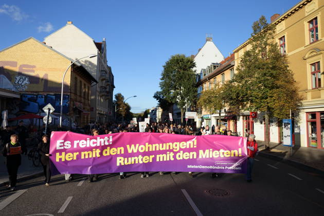 Protesters march down Karl Liebknecht Street carrying a banner reading Enough Is Enough—Give Us Housing, Lower the Rents during a demonstration against the housing crisis and rising rents, Potsdam, October 10, 2026. Rent Protest in Potsdam