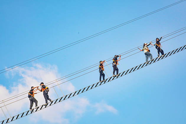 China Sky Ladder Challenger Tourists climb up a 250-meter-long soft ladder between two mountains in Mingtangshan Scenic Area in Yuexi county in central China s Anhui province, Sunday, Oct. 11, 2026. The rope ladder has 620 steps and a vertical distance of 365 meters. It opened to tourists in June this year, and quickly became a tourist attraction., Credit:stringer Utuku Feature China Avalon CHINA, ANHUI, YUEXI Copyright: xstringerx xUtuku FeaturexChinax xAvalonx 1142342712