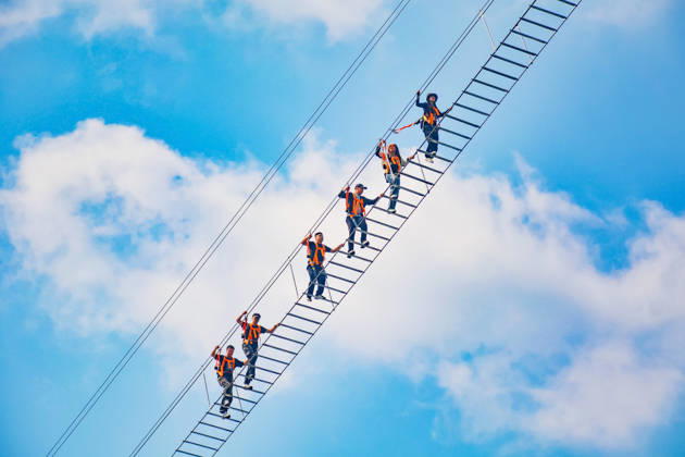 China Sky Ladder Challenger Tourists climb up a 250-meter-long soft ladder between two mountains in Mingtangshan Scenic Area in Yuexi county in central China s Anhui province, Sunday, Oct. 11, 2026. The rope ladder has 620 steps and a vertical distance of 365 meters. It opened to tourists in June this year, and quickly became a tourist attraction., Credit:stringer Utuku Feature China Avalon CHINA, ANHUI, YUEXI Copyright: xstringerx xUtuku FeaturexChinax xAvalonx 1142342722