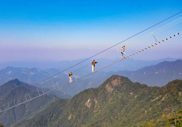 China Sky Ladder Challenger Tourists climb up a 250-meter-long soft ladder between two mountains in Mingtangshan Scenic Area in Yuexi county in central China s Anhui province, Sunday, Oct. 11, 2026. The rope ladder has 620 steps and a vertical distance of 365 meters. It opened to tourists in June this year, and quickly became a tourist attraction., Credit:stringer Utuku Feature China Avalon CHINA, ANHUI, YUEXI Copyright: xstringerx xUtuku FeaturexChinax xAvalonx 1142342744