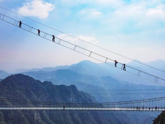 China Sky Ladder Challenger Tourists climb up a 250-meter-long soft ladder between two mountains in Mingtangshan Scenic Area in Yuexi county in central China s Anhui province, Sunday, Oct. 11, 2026. The rope ladder has 620 steps and a vertical distance of 365 meters. It opened to tourists in June this year, and quickly became a tourist attraction., Credit:stringer Utuku Feature China Avalon CHINA, ANHUI, YUEXI Copyright: xstringerx xUtuku FeaturexChinax xAvalonx 1142342747