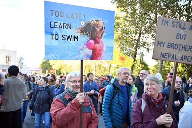 Tens of thousands march in Brussels demanding stronger climate action BRUSSELS, BELGIUM - OCTOBER 11: Demonstrators hold climate-themed placards as tens of thousands of people march through Brussels calling for stronger action against climate change and reduced dependence on fossil fuels, on October 11, 2026 in Brussels, Belgium. The protest was organized by the Belgian Climate Coalition, which brings together around 100 civil society organizations. Participants marched along major roads toward Schuman Square, home to several European Union institutions, while protesting the government s climate policies. Dursun Aydemir Anadolu Brussels Belgium. Editorial use only. Please get in touch for any other usage. Copyright: x2026xAnadoluxDursunxAydemirx