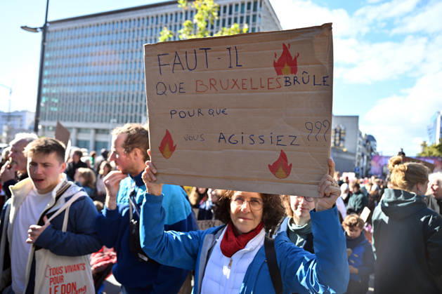 Tens of thousands march in Brussels demanding stronger climate action BRUSSELS, BELGIUM - OCTOBER 11: Demonstrators hold climate-themed placards as tens of thousands of people march through Brussels calling for stronger action against climate change and reduced dependence on fossil fuels, on October 11, 2026 in Brussels, Belgium. The protest was organized by the Belgian Climate Coalition, which brings together around 100 civil society organizations. Participants marched along major roads toward Schuman Square, home to several European Union institutions, while protesting the government s climate policies. Dursun Aydemir Anadolu Brussels Belgium. Editorial use only. Please get in touch for any other usage. Copyright: x2026xAnadoluxDursunxAydemirx