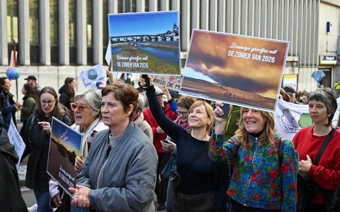 Tens of thousands march in Brussels demanding stronger climate action BRUSSELS, BELGIUM - OCTOBER 11: Demonstrators hold climate-themed placards as tens of thousands of people march through Brussels calling for stronger action against climate change and reduced dependence on fossil fuels, on October 11, 2026 in Brussels, Belgium. The protest was organized by the Belgian Climate Coalition, which brings together around 100 civil society organizations. Participants marched along major roads toward Schuman Square, home to several European Union institutions, while protesting the government s climate policies. Dursun Aydemir Anadolu Brussels Belgium. Editorial use only. Please get in touch for any other usage. Copyright: x2026xAnadoluxDursunxAydemirx