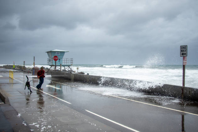 October 11, 2026, Oceanside, California, USA: An Oceanside man and his dog brave historic El NioÂ±o tidal swells on October 10, 2026. These Kelvin Waves have brought major damages to the Southern California coastline. Oceanside USA  - ZUMAg219 20261011_znp_g219_009 Copyright: xJakexLeexGreenx