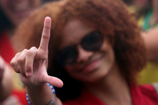 October 12, 2026, Rio De Janeiro, Rio De Janeiro, Brazil: A supporter flashes an L for Lula as thousands of supporters gather in Copacabana, Rio de Janeiro, Brazil, on October 12, 2026, for a pro-democracy demonstration organized by the CENA Nacional movement, the National Union of Students (UNE) and Universibloco. Held on Brazilâ€⠢s Our Lady of Aparecida national holiday, the rally calls for the defense of constitutional rights and public policies supporting healthcare, education and social assistance. Carnival street bands, known as blocos, and percussion groups brought music and a festive atmosphere to the waterfront mobilization, blending political activism with Rioâ€⠢s popular street culture. The demonstration takes place ahe - ZUMAk251 20261012_znp_k251_005 Copyright: xBobxKarpx
