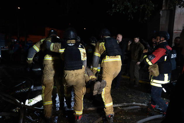 October 12, 2026, Kharkiv, Kharkiv Oblast, Ukraine: Rescuers load an injured firefighter into an ambulance after a sustained injury clearing debris at a Russian cruise missile strike on a residential area in Kharkiv, Ukraine, 2026. Kharkiv Ukraine - ZUMAm350 20261012_zip_m350_005 Copyright: xCameronxJones-Manleyx
