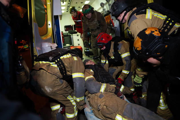 October 12, 2026, Kharkiv, Kharkiv Oblast, Ukraine: Rescuers load an injured firefighter into an ambulance after a sustained injury clearing debris at a Russian cruise missile strike on a residential area in Ukraine. Kharkiv Ukraine  - ZUMAm350 20261012_zip_m350_006 Copyright: xCameronxJones-Manleyx