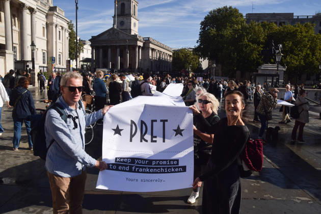 October 13, 2026, London, England, United Kingdom: Protesters pass through Trafalgar Square with a long pledge to boycott Pret signed by 100,000 people during the march to Pret headquarters urging the fast food chain to drop Frankenchickens. Frankenchickens are chickens mostly raised on factory farms who are bred to grow much faster and who are said to suffer far more than regular chickens. London United Kingdom - ZUMAv130 20261013_zip_v130_028 Copyright: xVukxValcicx