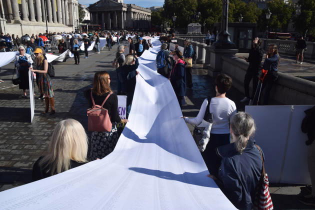 October 13, 2026, London, England, United Kingdom: Protesters pass through Trafalgar Square with a long pledge to boycott Pret signed by 100,000 people during the march to Pret headquarters urging the fast food chain to drop Frankenchickens. Frankenchickens are chickens mostly raised on factory farms who are bred to grow much faster and who are said to suffer far more than regular chickens. London United Kingdom  - ZUMAv130 20261013_zip_v130_029 Copyright: xVukxValcicx