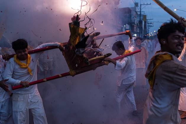 October 13, 2026, Trang, Thailand: Devotees set off firecrackers during a street procession in the Vegetarian Festival..The annual Vegetarian Festival is held in Bangkok and many parts of southern Thailand, including Trang, Phatthalung, and Phuket, where worshippers refrain from eating animal products over the nine days, coinciding with the celebration of the Nine Emperor Gods. Trang Thailand  - ZUMAs197 20261013_aaa_s197_174 Copyright: xPeeraponxBoonyakiatx